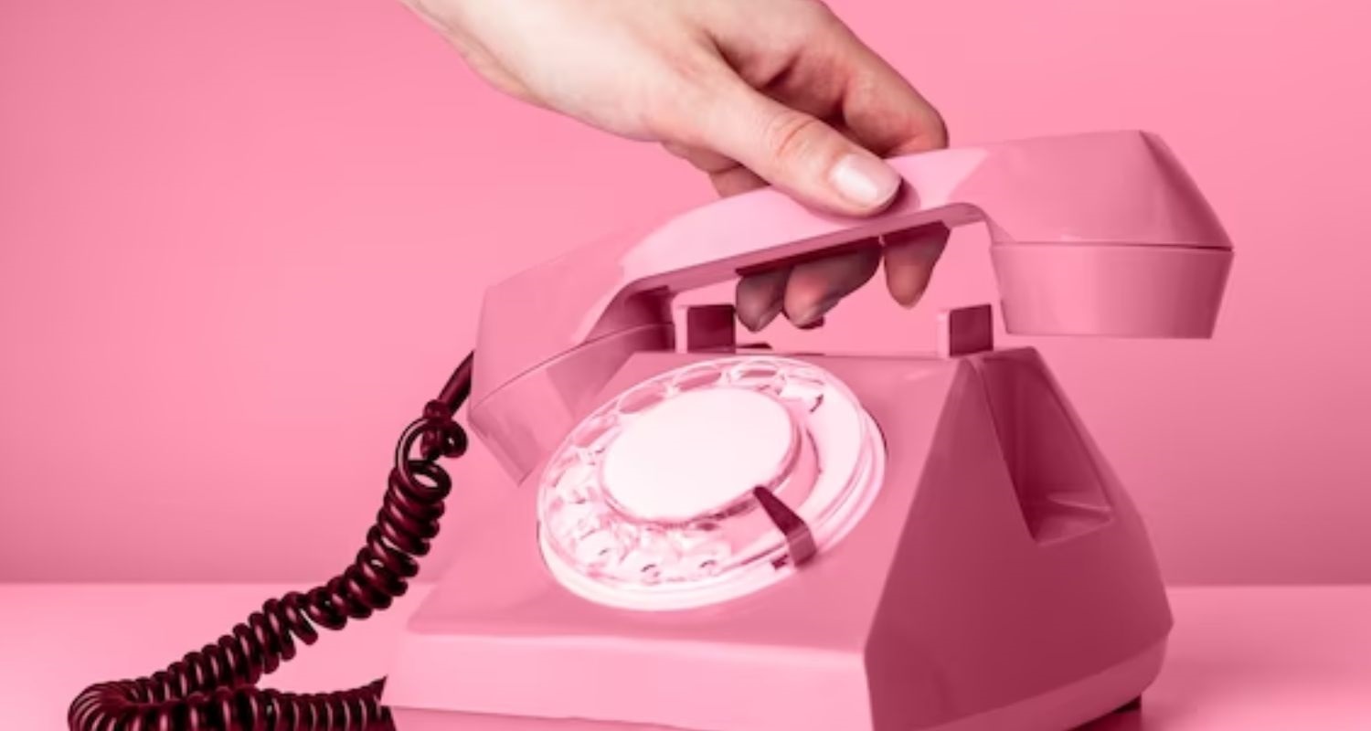 hand holding pink phone, hold please annual skincare packages are coming soon to evolvmd medspa
